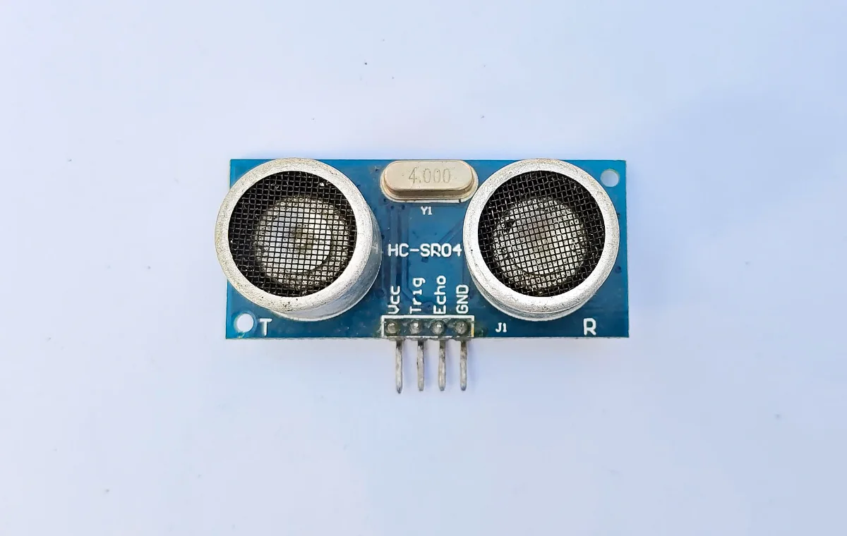 HC-SR04 ultrasonic sensor module showing the 40 kHz transmitter and receiver transducers, the control PCB and the four-pin header.